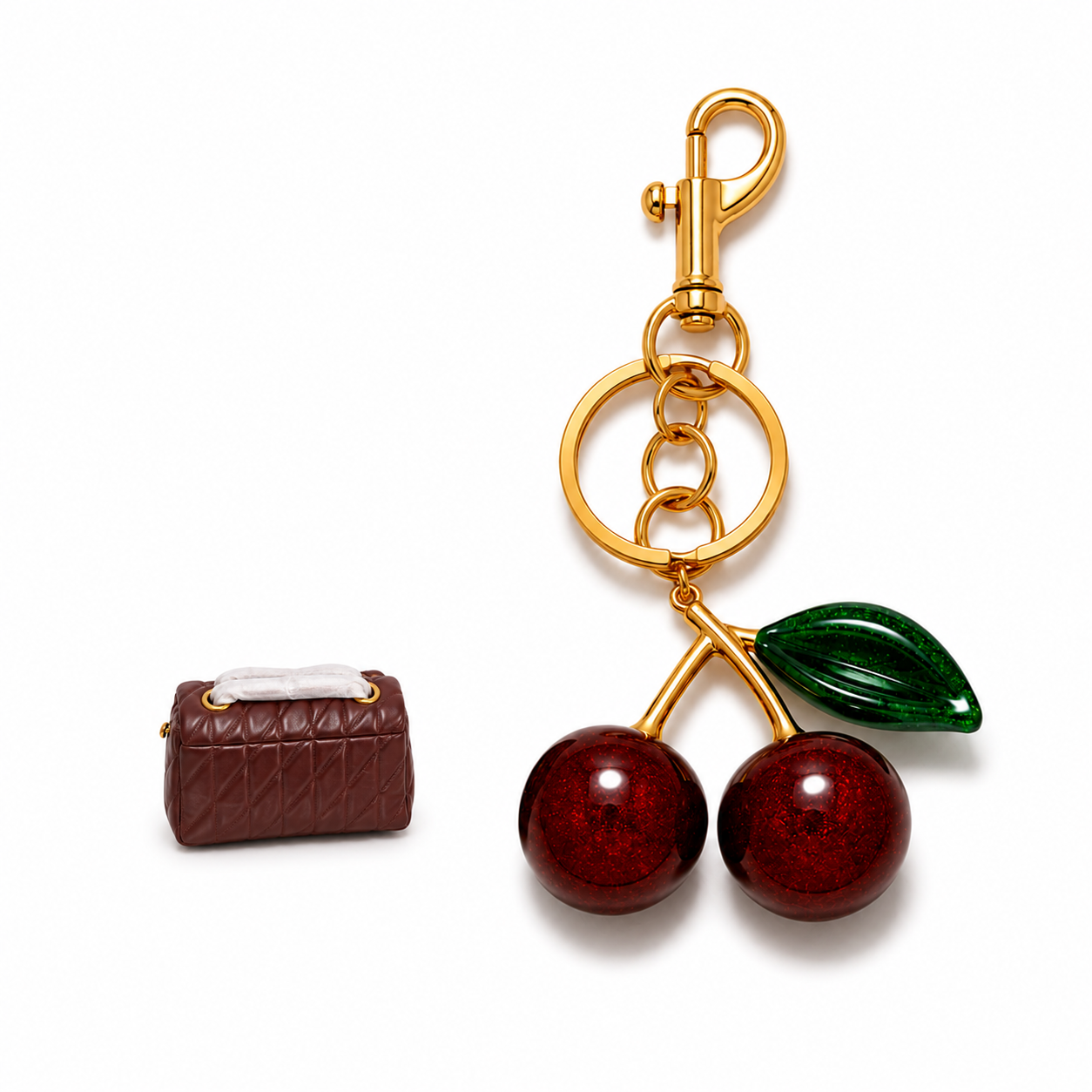 Cherry bag charm paired with a burgundy handbag